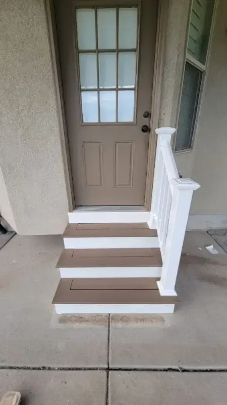 Entry steps rebuilt with composite treads and a new white handrail post