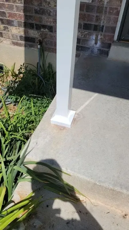 Porch post rebuilt, wrapped and painted white with new base trim at a concrete porch