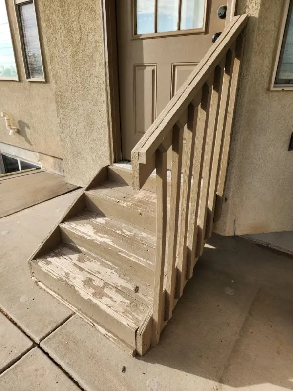 Staircase mid-renovation with the treads removed and the railing still in place