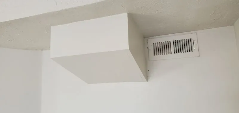 Finished drywall soffit with a ceiling air vent