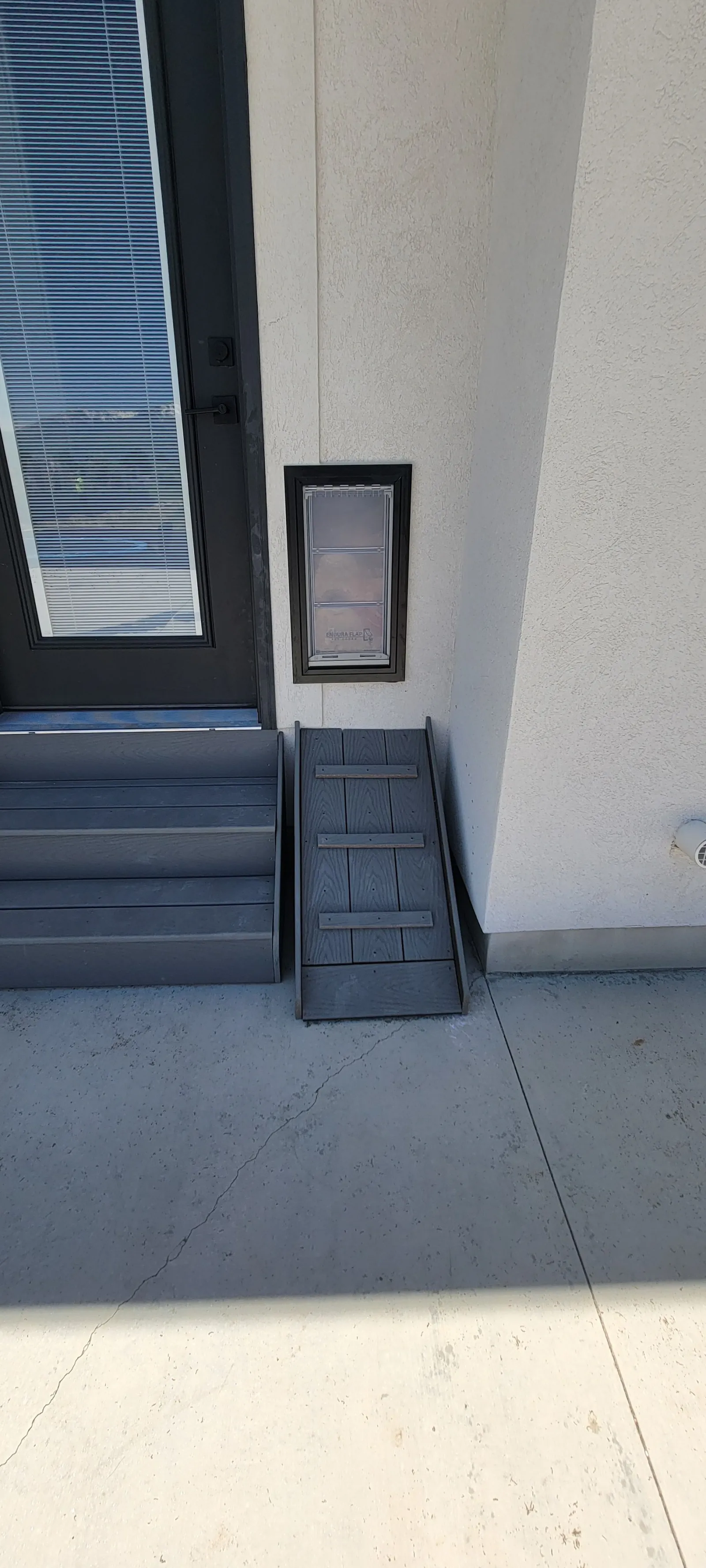 Dark painted exterior steps leading up to an entry door